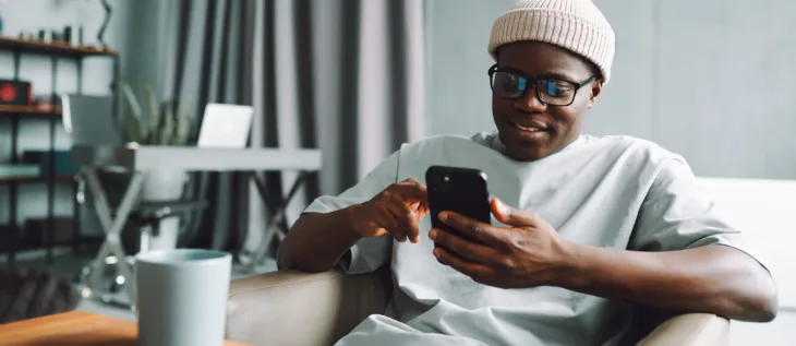 An individual on their phone reviewing various consumer tech products