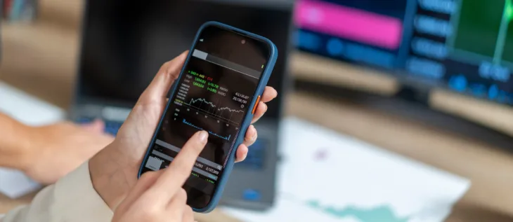 An investor that is looking at ETF investments on their phone