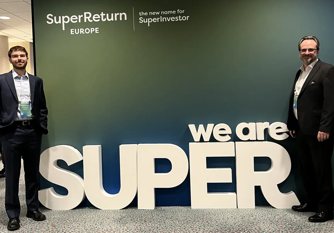 SuperReturn-Europe-SuperReturn’s Tale of Two Markets – Europe Finds Its Edge Stephen Fishleigh and Dan Abramson standing in front of SuperReturn Europe signage