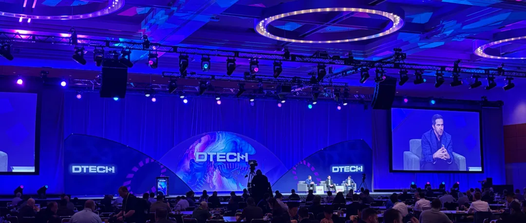 4 Trends in Energy Infrastructure From Distributech 2026 Panel discussion on stage at Distributech 2026 with the DTECH logo displayed on large screens as energy leaders discuss trends in energy infrastructure and grid reliability.