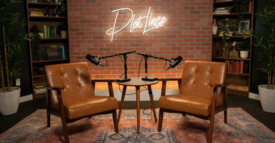 PlotLines-Episode-41-From Hotels to High-Rises How Hospitality Is Redefining the Residential Experience Podcast studio setup with two leather chairs and microphones beneath a PlotLines sign, representing a discussion on how hospitality principles are shaping modern residential living.