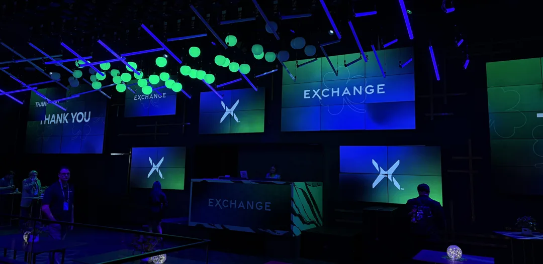Exchange conference event space with branded screens and lighting, representing ETF industry discussions on market trends and issuer strategy.